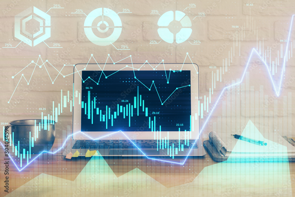 Forex market graph hologram and personal computer on background. Multi exposure. Concept of investment. Forex market graph hologram and personal computer on background. Multi exposure. Concept of investment.