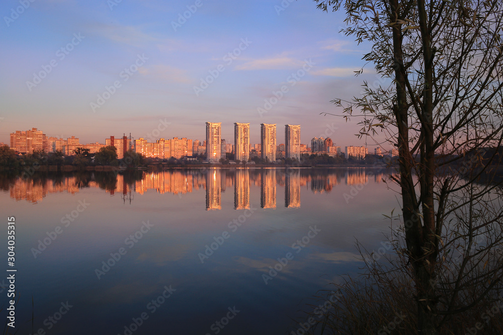 Reflection of houses at sunset in the lake