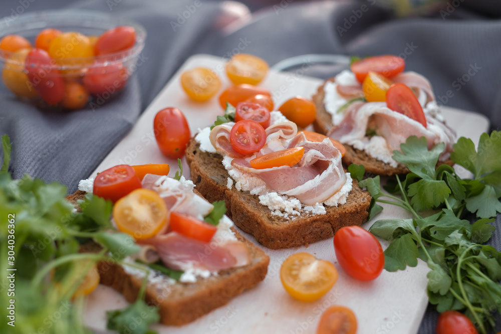 toasts with curd cheese, bacon, herbs and tomatoes toasts with curd cheese, bacon, herbs and tomatoes