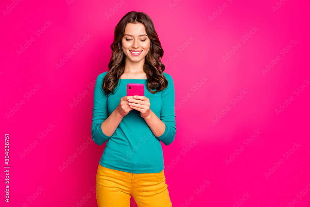 Photo of cheerful positive girlfriend browsing through smartphone smiling toothily reading feednews isolated pink vivid color background Photo of cheerful positive girlfriend browsing through smartphone smiling toothily reading feednews isolated pink vivid color background