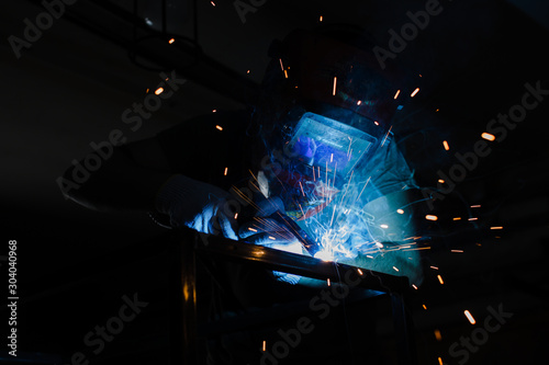 Portrait of a welder at work with a welding machine.