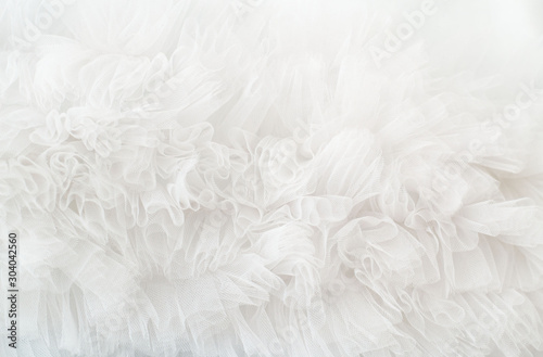 White ruffled wavy background. Soft tule cloth photo