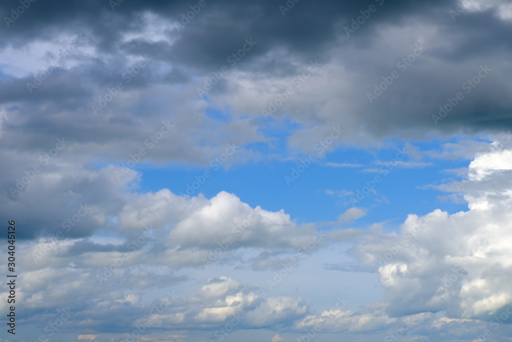 Fototapeta premium Beautiful blue sky with white gorgeous and dark fluffy cloudy flowing with the wind