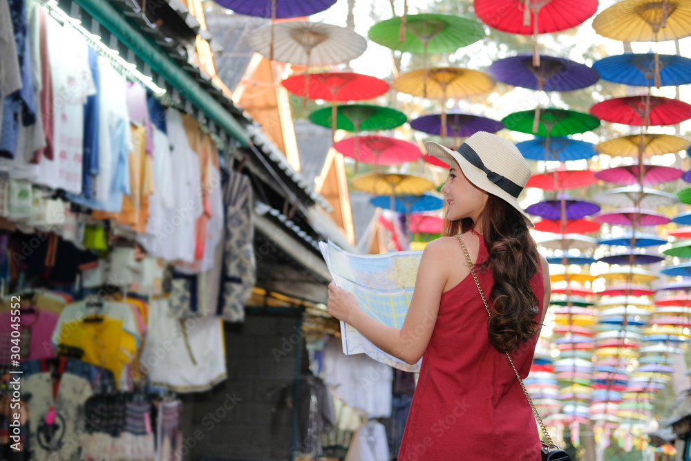 woman traveler tourist with map traveling on walking street. journey trip travel concept woman traveler tourist with map traveling on walking street. journey trip travel concept