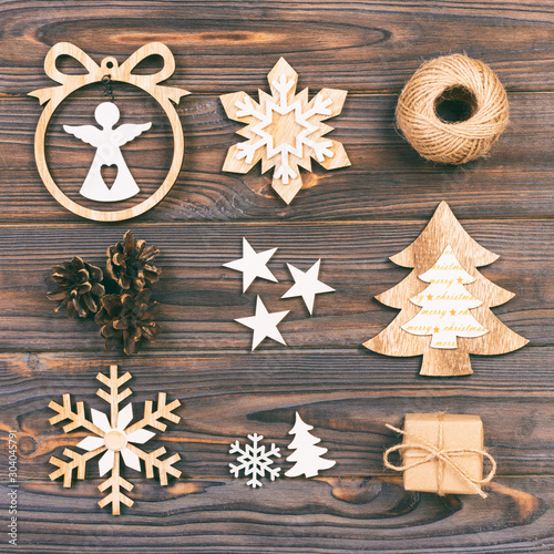 Christmas composition. Christmas snowflakes, Christmas tree and angel in a frame on a wooden background. New Year wooden decorations. Toned