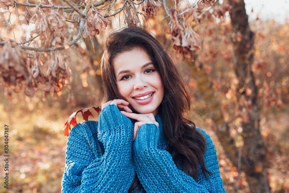 Close-up portrait of beautiful smiling woman in autumn park Close-up portrait of beautiful smiling woman in autumn park