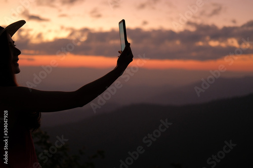 woman use smart phone to take photo. traveler tourist travel on holiday vacation. journey trip concept