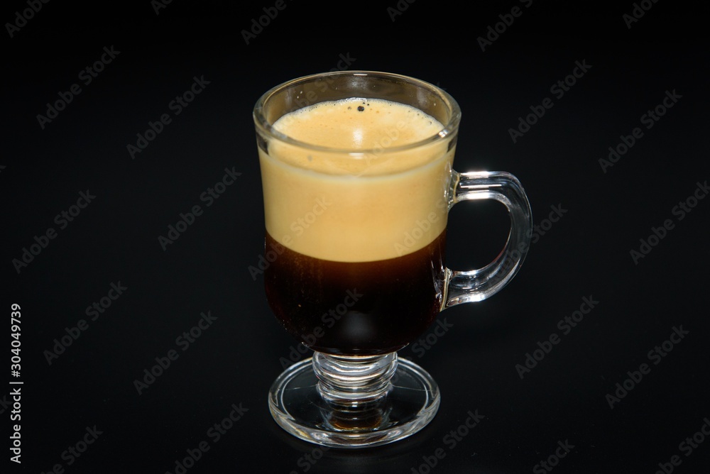 Very creamy espresso shot mug on black background Very creamy espresso shot mug on black background