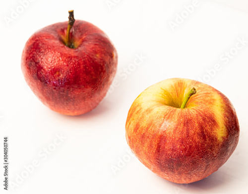 Red apple with drops isolated on white.