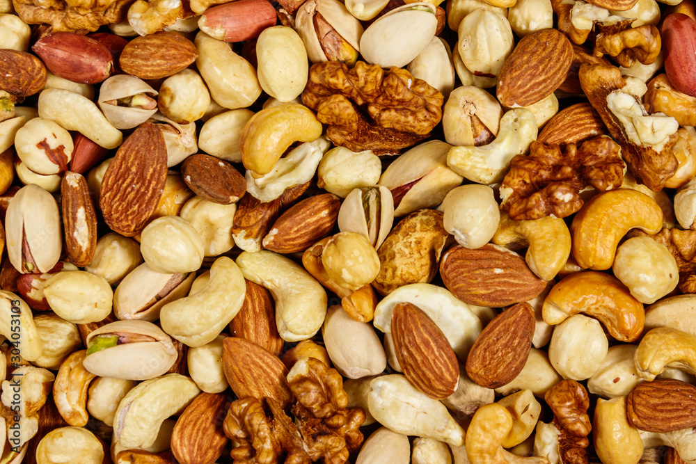 Background of mixed nuts (walnuts, pistachio, almond, peanut, cashew, hazelnut). Healthy eating concept Background of mixed nuts (walnuts, pistachio, almond, peanut, cashew, hazelnut). Healthy eating concept