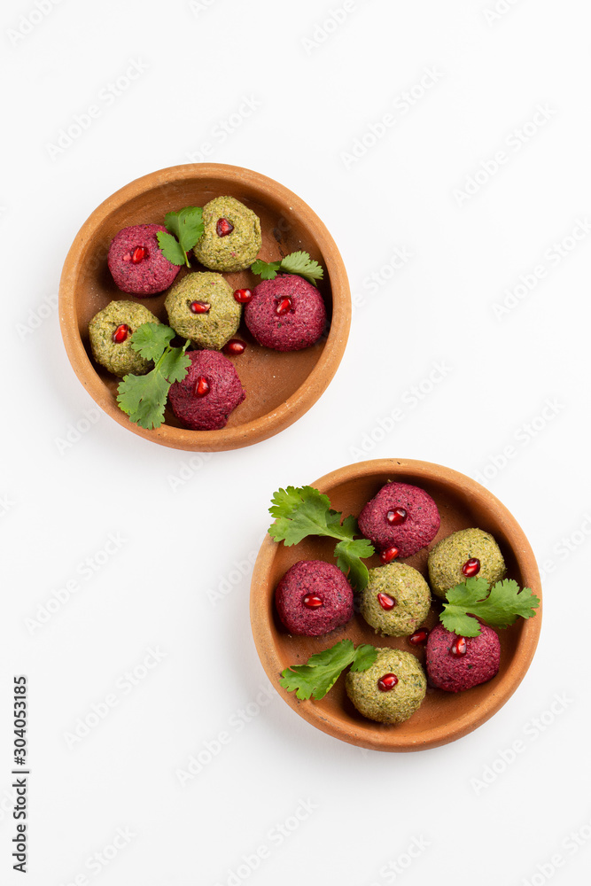 Traditional georgian pkhali with beans, beetroot, spinach and pomegranate isloated on white Traditional georgian pkhali with beans, beetroot, spinach and pomegranate isloated on white