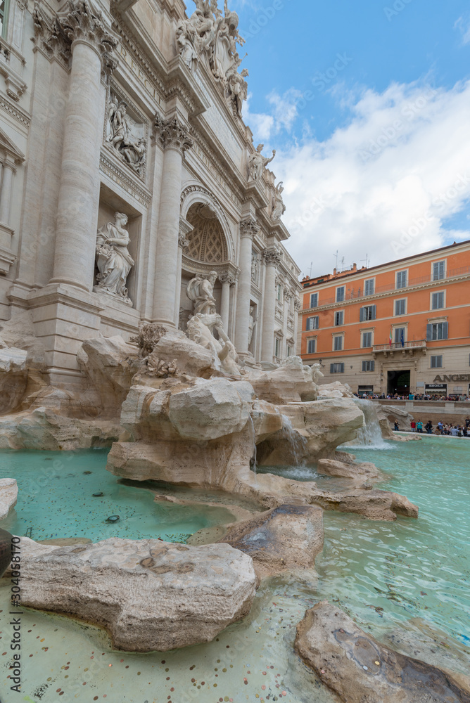 Rome, Italy - October 07, 2018: The Trevi Fountain standing 26 meters high and 20 meters wide, it is the largest Baroque fountain in the city. Fountain di Trevi surronded by hundreds of tourists Rome, Italy - October 07, 2018: The Trevi Fountain standing 26 meters high and 20 meters wide, it is the largest Baroque fountain in the city. Fountain di Trevi surronded by hundreds of tourists