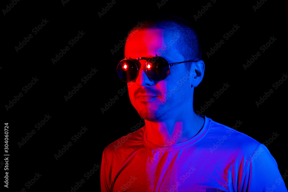 Portrait of man with sunglasses with red and blue color lights Portrait of man with sunglasses with red and blue color lights