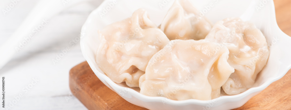 Fresh, delicious boiled pork, shrimp gyoza dumplings on white background with soy sauce and chopsticks, close up, lifestyle. Homemade design concept. Fresh, delicious boiled pork, shrimp gyoza dumplings on white background with soy sauce and chopsticks, close up, lifestyle. Homemade design concept.