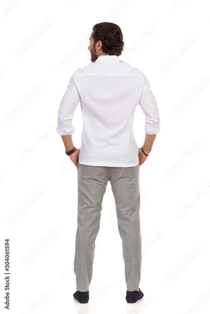Rear View Of Standing Elegant Man In Gray Trousers And White Shirt. Rear View Of Standing Elegant Man In Gray Trousers And White Shirt.
