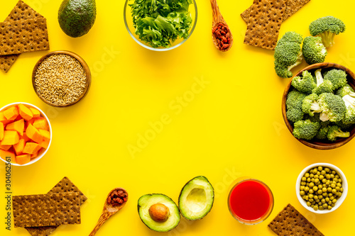 Healthy food. Vegatables and fruits on yellow background top view frame copy space