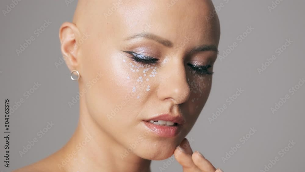 Cropped view of beautiful young hairless woman with fashion ...