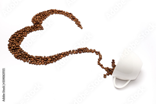 Coffee beans arrange as heart shape drop into cup on white background