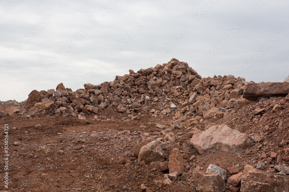 Close-up of hills stacked with dirt and stone engineering materials on the construction site