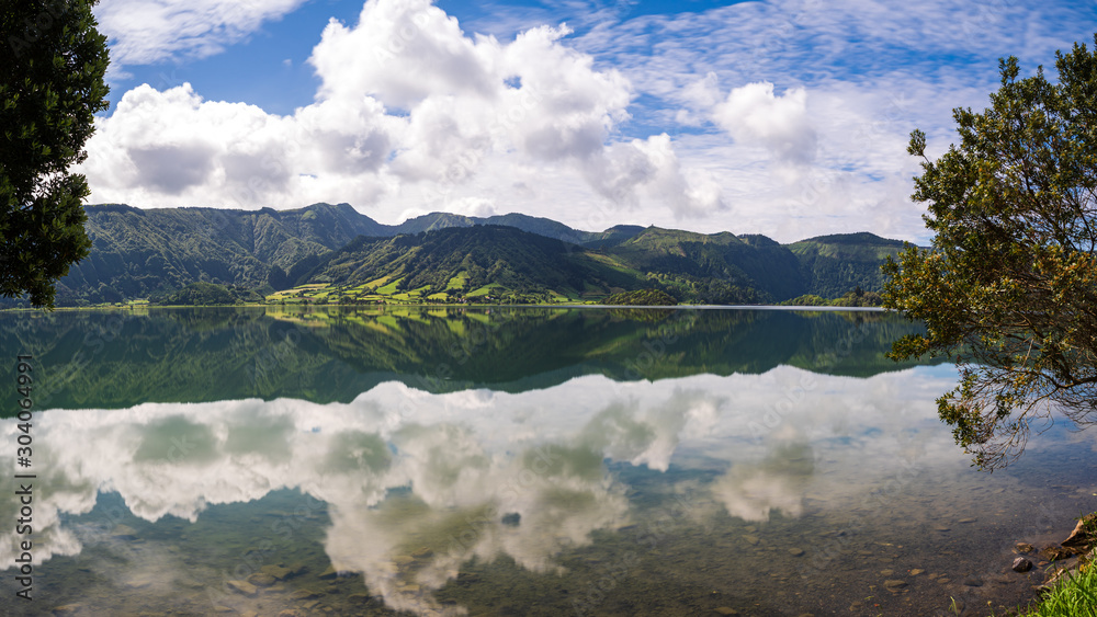 Reflections of the green mountains on the 