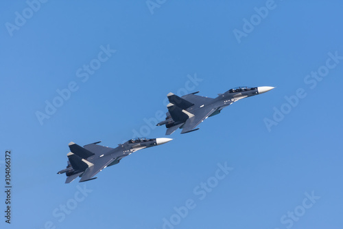 Pair of fighters flying in tight formation. photo