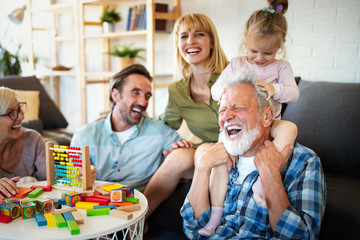 Senior grandparents playing with grandchildren and having fun with family