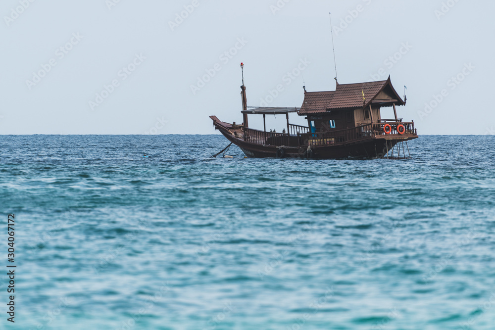 Wooden ship anchors in bay