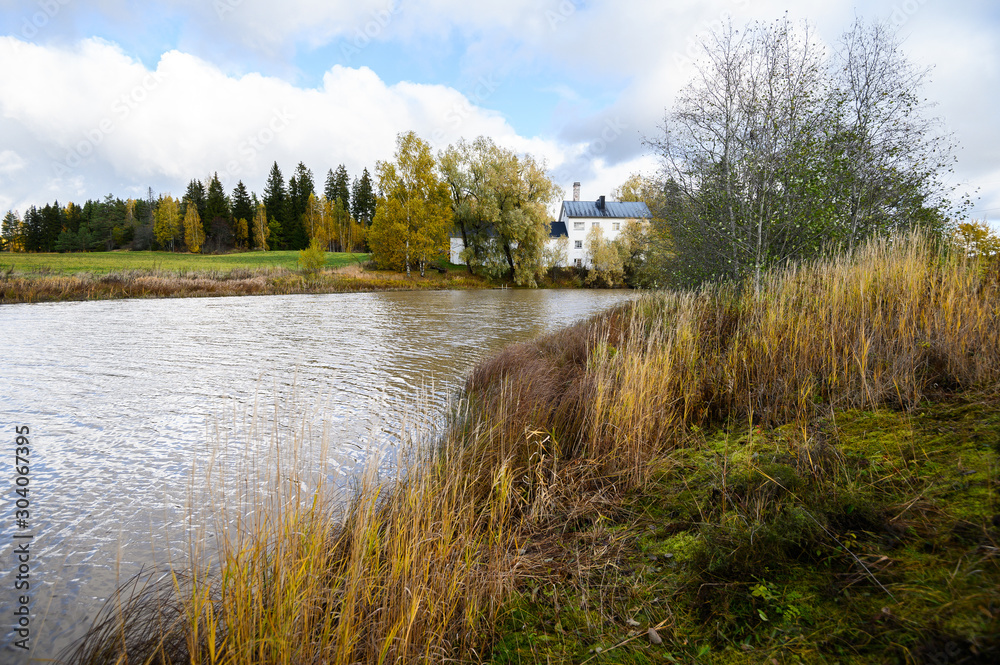 the River among the fields, the white house on the shore. Beautiful autumn landscape. Helsinki, Finland