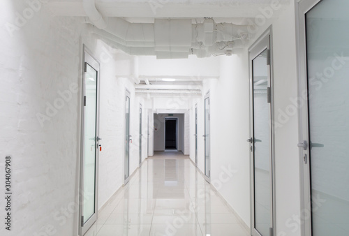 Deep hospital corridor with closed doors in chambers