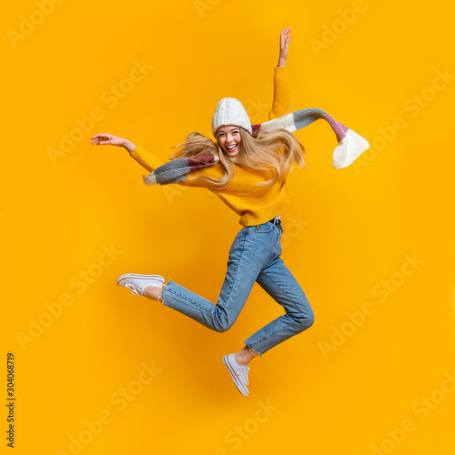 Cheerful winter girl enjoying her life, flying in the air photo