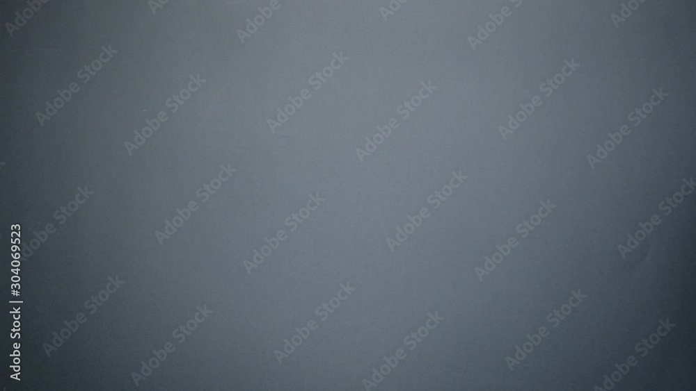 Close up of gift box falls on female hand on grey background. St. Valentine's Day, International Women's Day, birthday, holiday concept. Mock up. Close up of gift box falls on female hand on grey background. St. Valentine's Day, International Women's Day, birthday, holiday concept. Mock up.