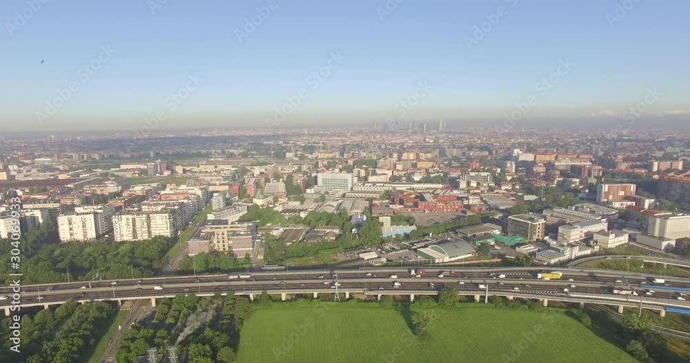 Milan, Italy. Outskirts of the city from the eastern side of the motorway, with the skyline in the distance. Milan, Italy. Outskirts of the city from the eastern side of the motorway, with the skyline in the distance.
