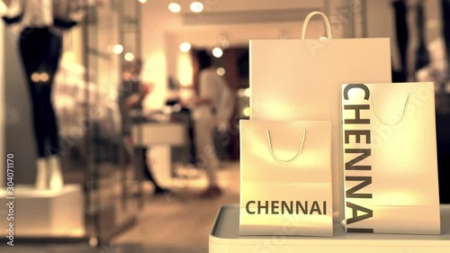 Wallpaper Mural Paper shopping bags with Chennai caption against blurred store entrance. Retail in India related 3D animation Torontodigital.ca
