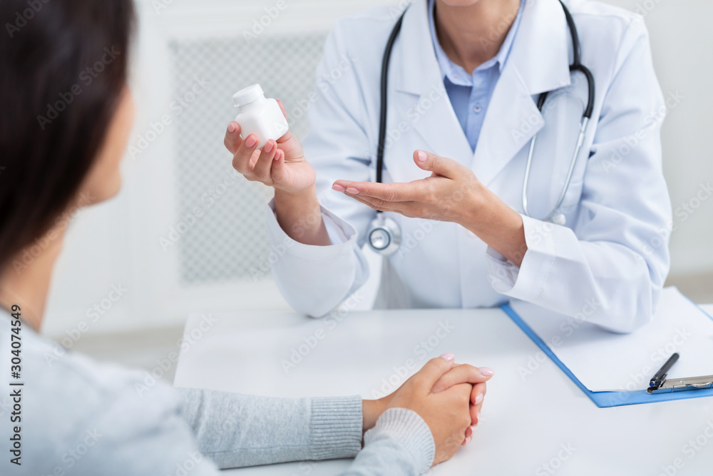 Doctor Giving Instructions On Treatment For Patient Sitting In Office Doctor Giving Instructions On Treatment For Patient Sitting In Office