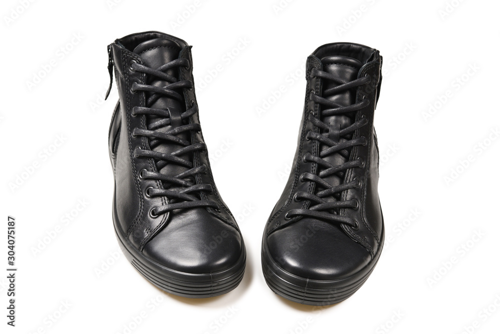 Men's black leather shoes and a black camera on a isolated on white background. Copy space.