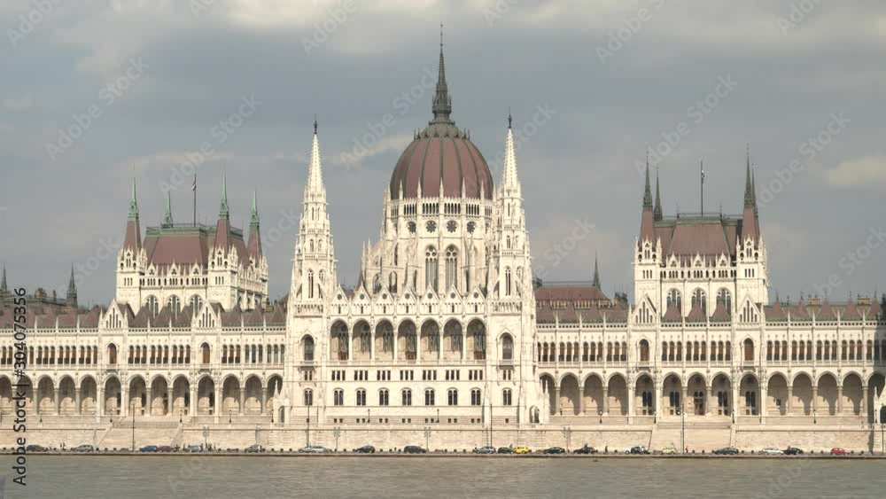 close tilt up shot of the danube river and hungarian parliament in budapest, hungary close tilt up shot of the danube river and hungarian parliament in budapest, hungary