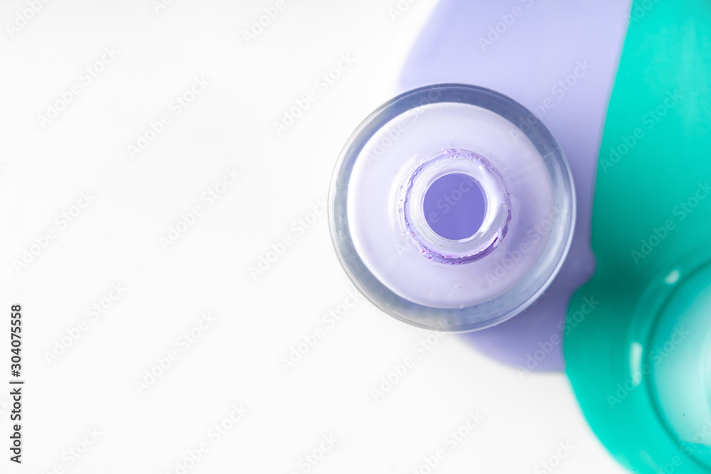 Pastel color spilled nail polish bottles over white Pastel color spilled nail polish bottles over white