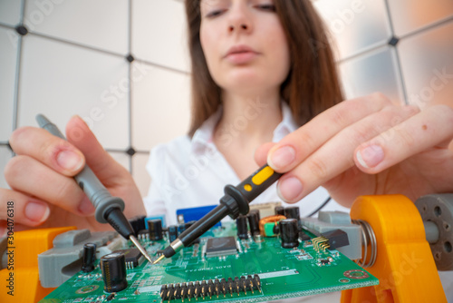 Wallpaper Mural Young woman with measuring devices in the electronics engineer  laboratory Torontodigital.ca