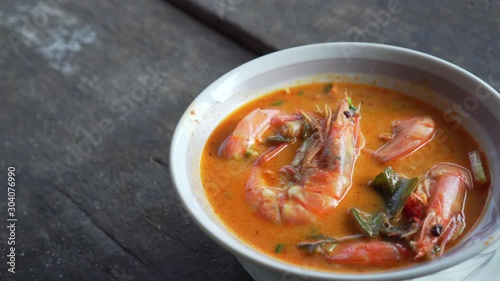 Spicy Soup with Prawn in a bowl. Hot soup. Tom Yum Goong. Thai Food. Slow pan shot
