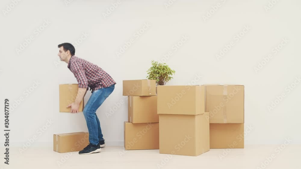 Handsome young man carrying out cardboard boxes, moving out. Handsome young man carrying out cardboard boxes, moving out.