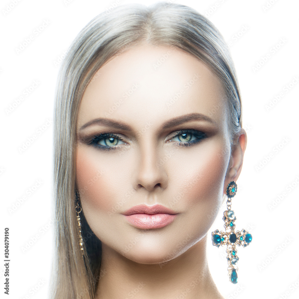 Beauty face of beautiful young fashion model woman, perfect skin, bright eye shadow make-up, jewelry earrings Beauty face of beautiful young fashion model woman, perfect skin, bright eye shadow make-up, jewelry earrings