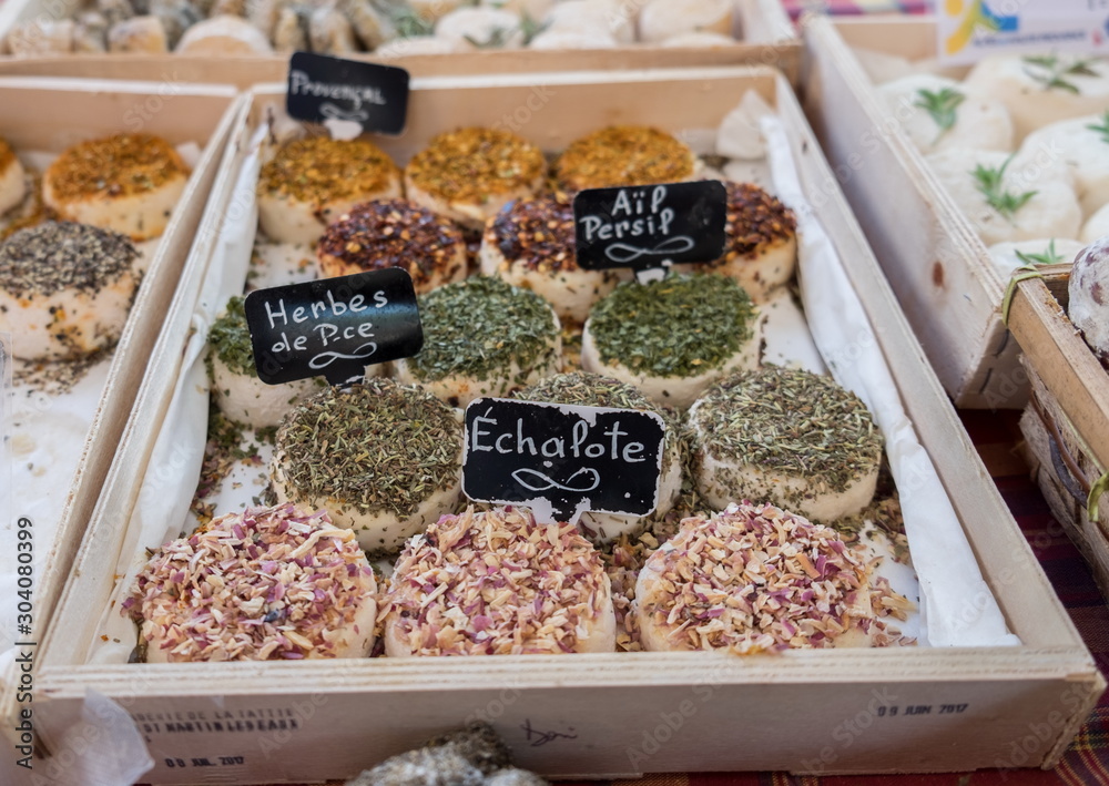 Φωτογραφία Assortment of different cheeses (on labels written: with shallot, herbs and garlic) sold at local city market