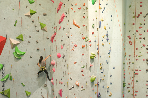 Girl climber training in climbing gym 