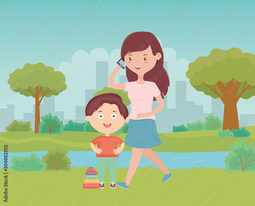 woman using smartphone and boy with toy in the park, kids toys