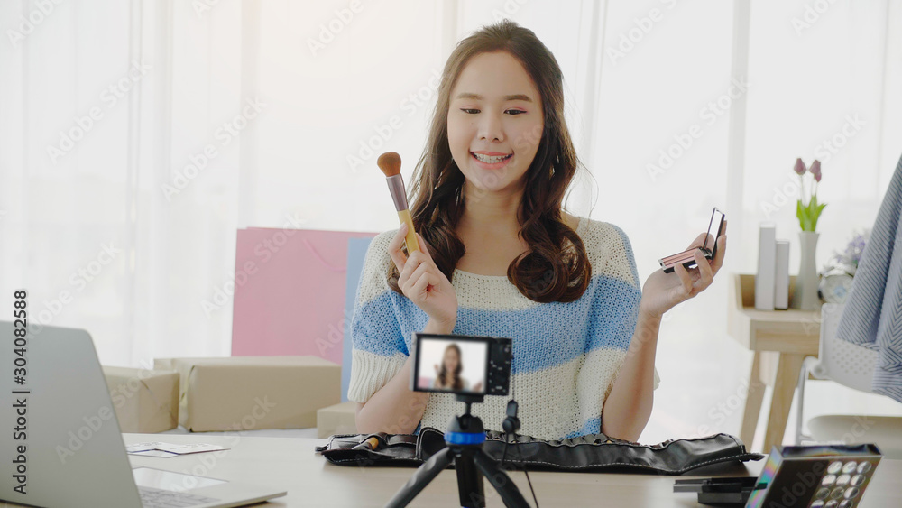 Asian women bloggers are vlog selling cosmetics, make-up, use camera demonstrations streame online Stay in the bedroom at home. Teenage girls are happy to make up beautiful. Online business concept Asian women bloggers are vlog selling cosmetics, make-up, use camera demonstrations streame online Stay in the bedroom at home. Teenage girls are happy to make up beautiful. Online business concept