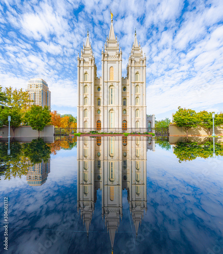 Classic panoramic view of famous Salt Lake Temple of The Church of Jesus Christ of Latter-day Saints on Temple Square with beautiful reflections on a sunny day in autumn, Salt Lake City, Utah, USA