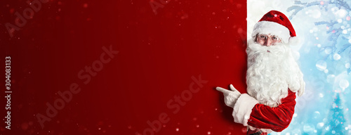 Santa Claus Holding Blank Advertisement Banner Red Background with Copy Space