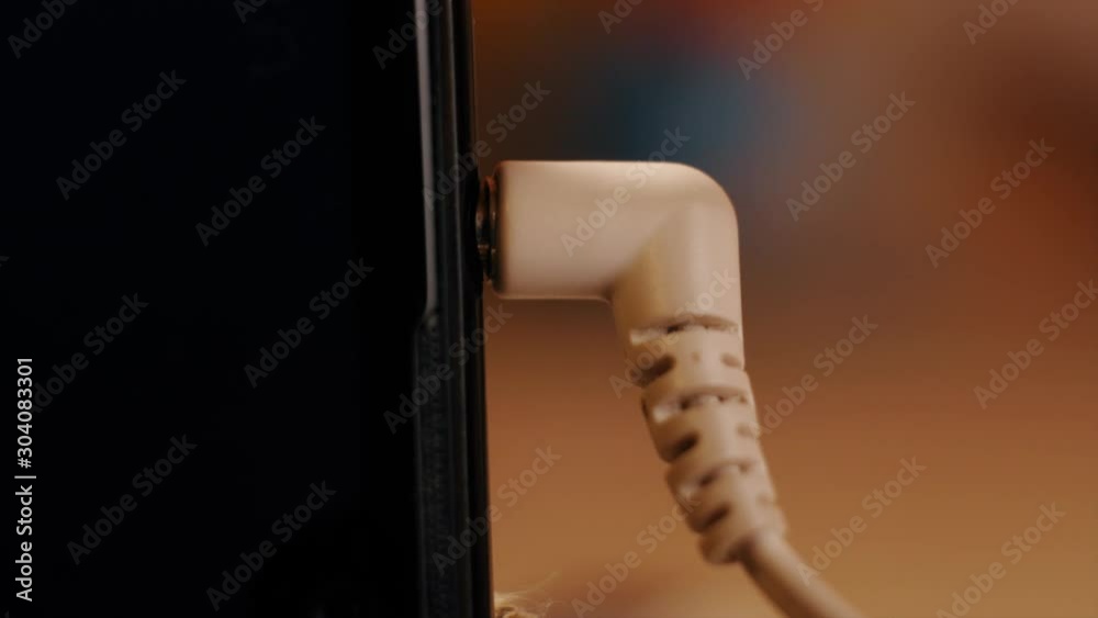 Connecting earphones to smart phone. Extreme closeup of headphone 3.5 mm jack plug. Connecting earphones to smart phone. Extreme closeup of headphone 3.5 mm jack plug.