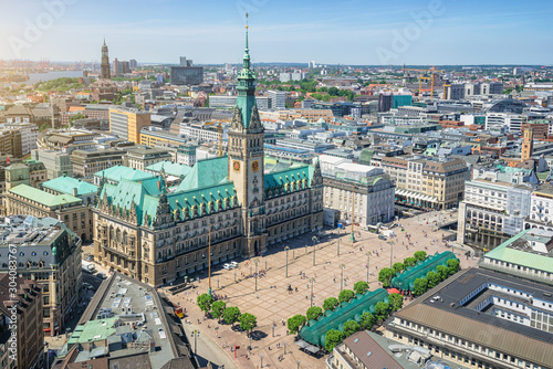 Beautiful aerial view of historic city center of hanseatic Hamburg with famous town hall at market square and ancient harbour district in the background on a sunny day with blue sky in summer, Germany