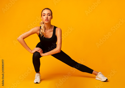 Fitness Woman Doing Side Lunge Stretch Working Out In Studio